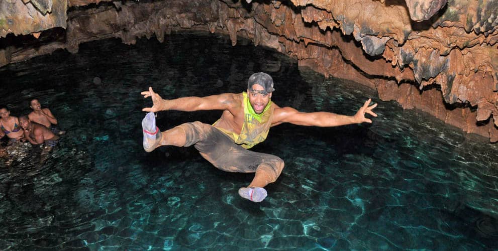 atv tour participant enjoying a stop at a subterranean natural pool