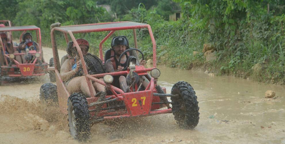 Group of couples on a muddy road during ATV tour
