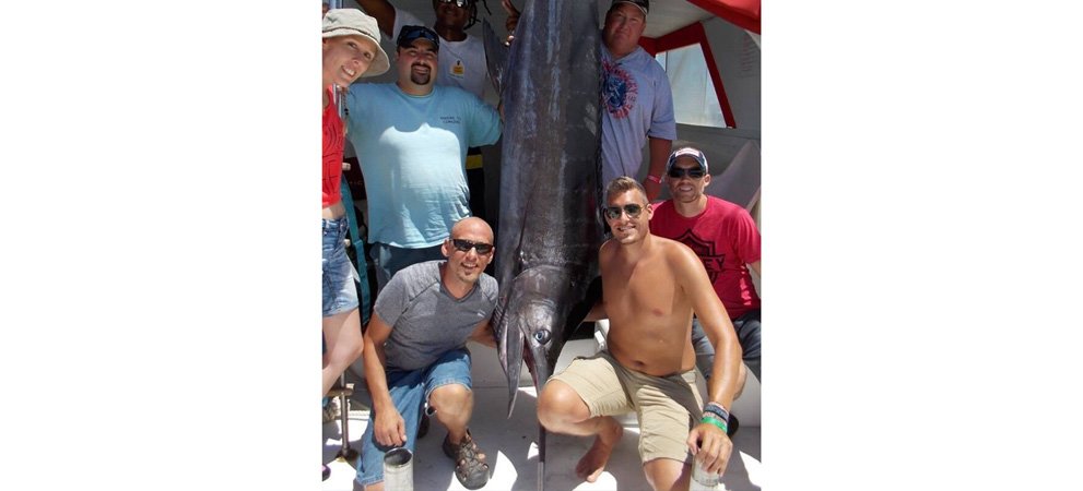 Tourist group fishing a marlin at Dominican Republic deep sea fishing tour