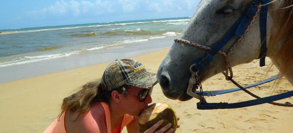 Tourist drinking from a coconut