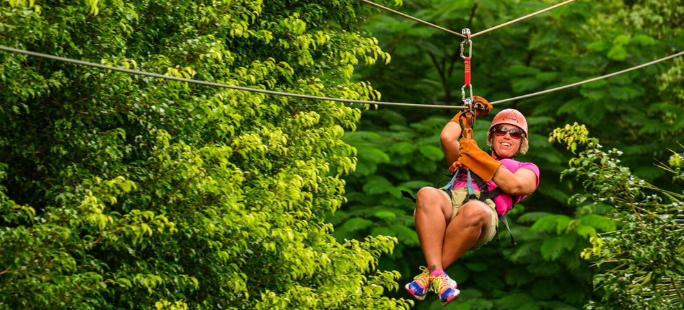 smiling participant enjoying zip lining