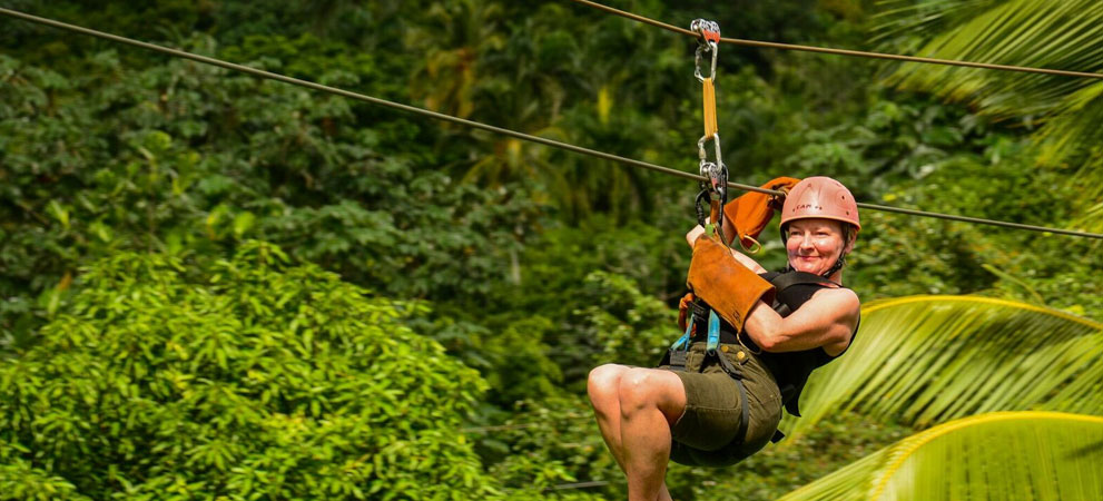 tourist enjoying the zip line ride through the dominican mountains